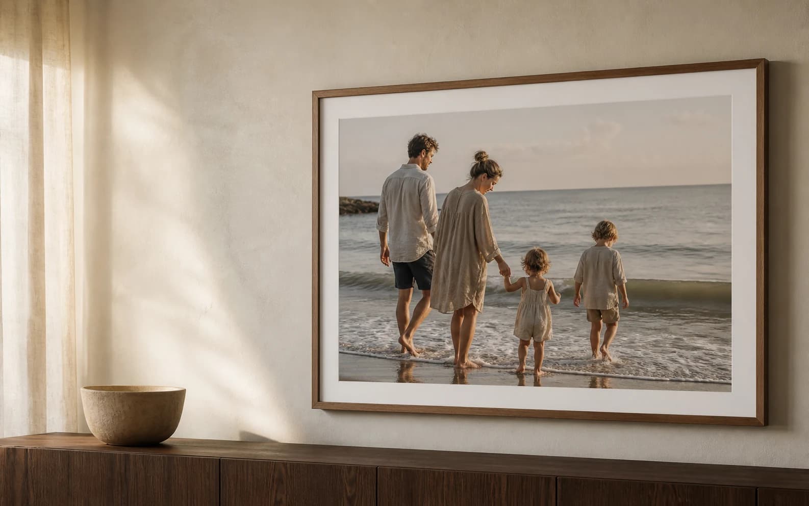 A family photograph in a premium walnut frame on the wall of a bright home